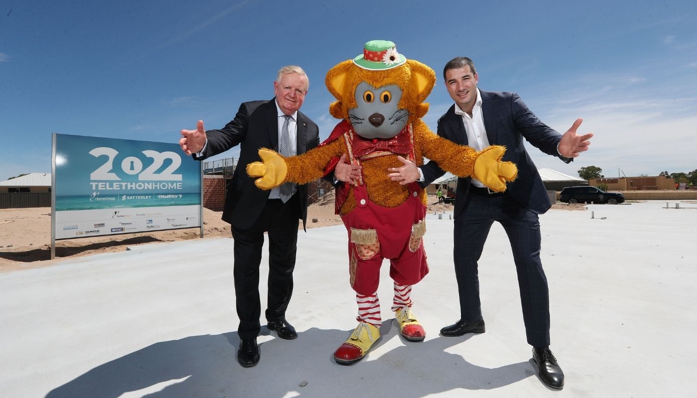 Nigel Satterley with Fat Cat and Anthony, standing on pad of 2022 Telethon Home
