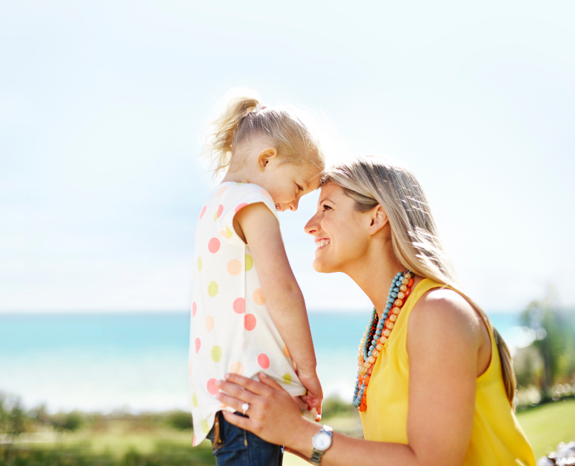 Young mother and daughter along the coast line