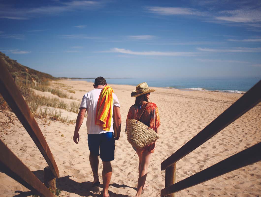 Young couple walking along the beach