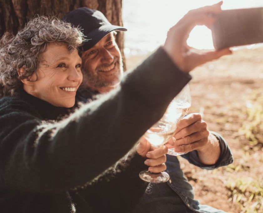 Robinson Grove, Bellevue, older couple cheering with a glass of wine