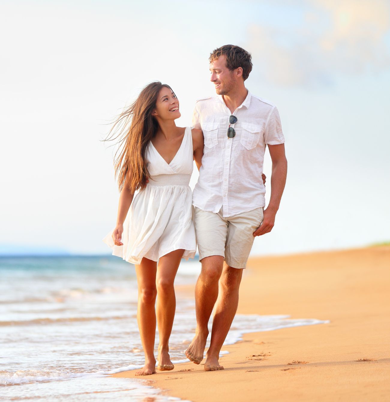 Eden Beach, Jindalee, young couple walking along the coast