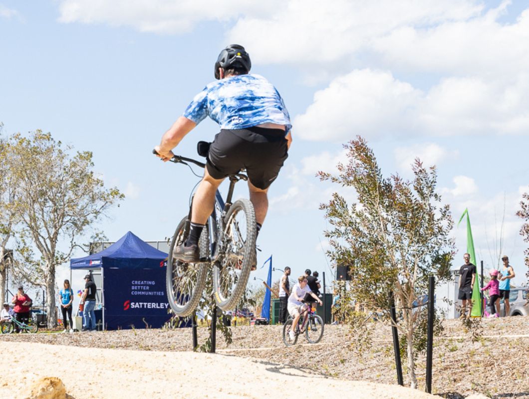 Allara, Eglinton Aduro park BMX bike pump track, young teen riding.
