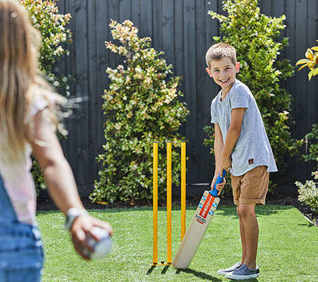 Maple Grove, Pakenham young children playing cricket in the backyard.