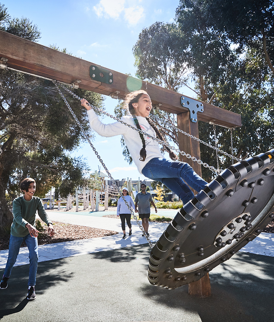 Maple Grove, Pakenham young children on swing at local park.