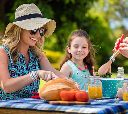 Smithfield Village, Smithfield mother and daughter sitting at local park picnic table enjoying lunch.