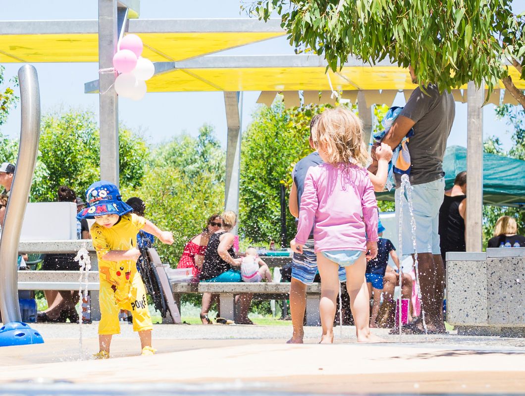 Allara, Eglinton young children playing in the Revolution park waterplay area.