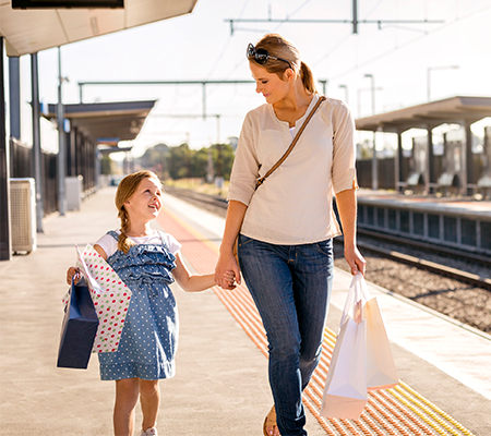 Arcadia, Officer holding shopping bags walking along train line