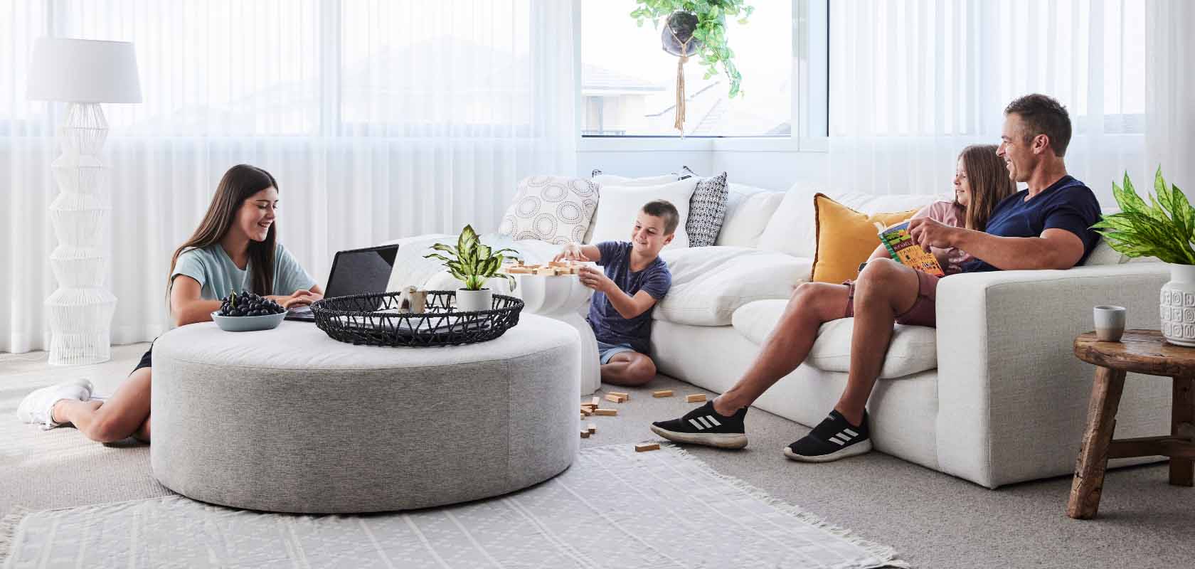 Heartford, Donnybrook young family sitting in lounge room playing games and reading books.