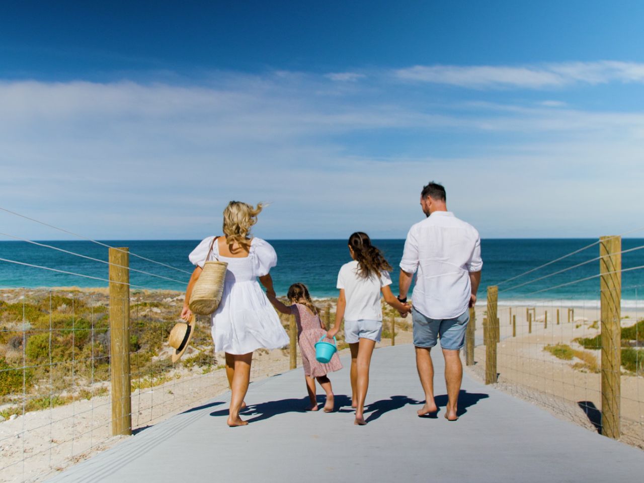Catalina, Mindarie and Clarkson, family of four walking down towards the beach