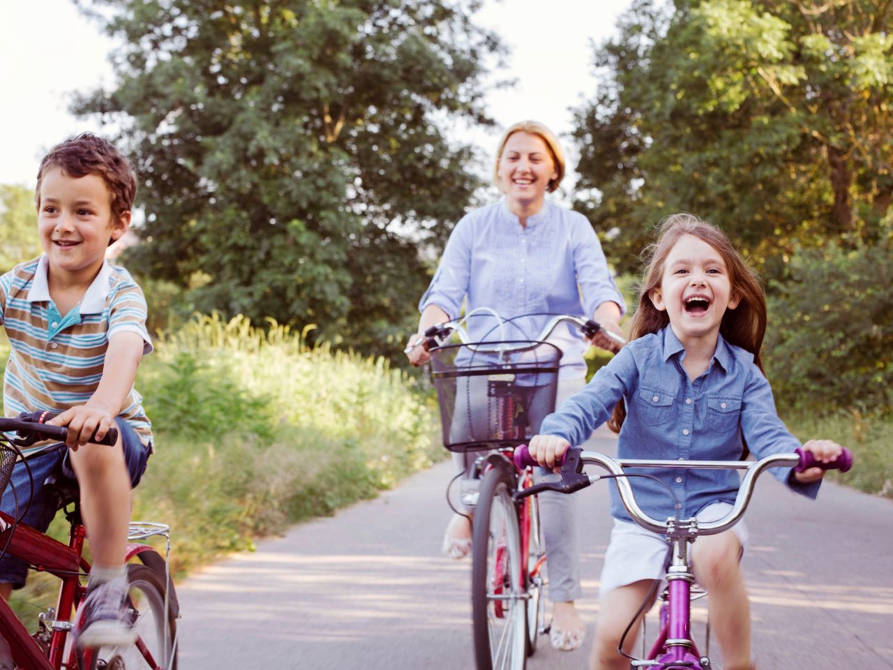 Young mother riding her bike with children