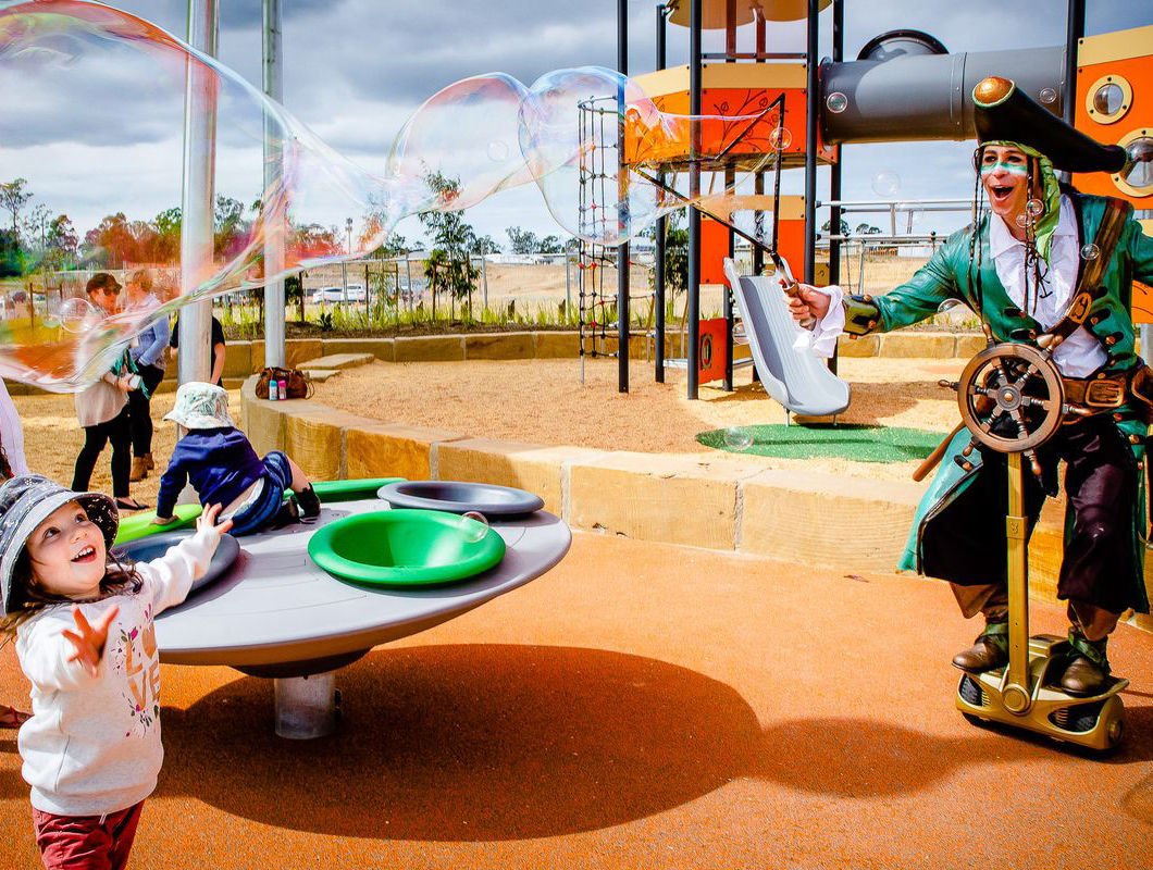 Ridgeview, Narangba event pirate blowing bubbles and children in the park.