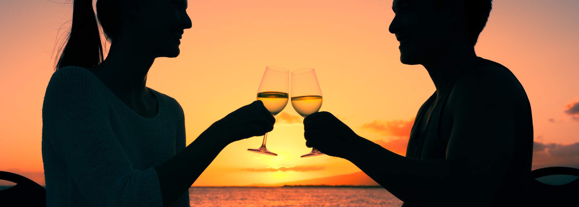 Eden Beach, Jindalee, young couple cheering with a glass of wine on Valentines day, along the coast