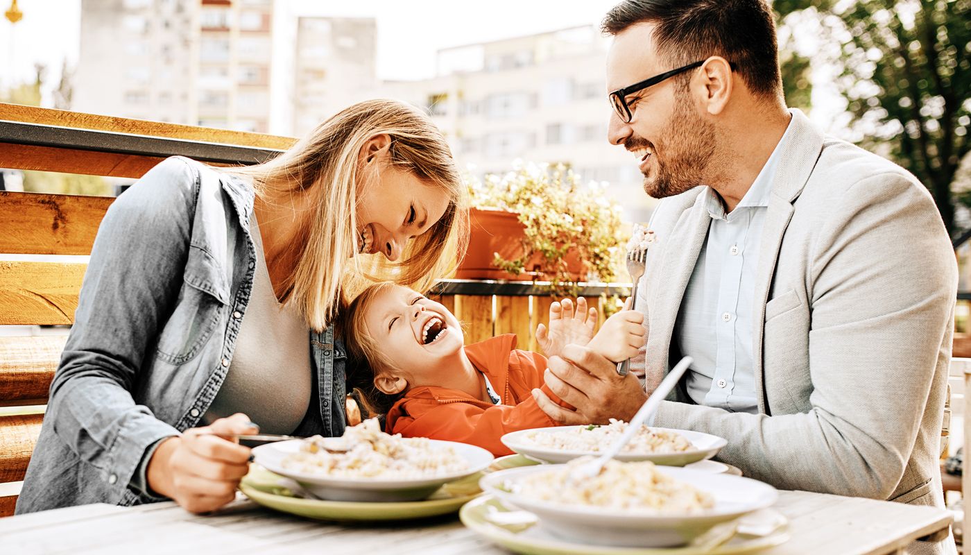 Young family enjoying food