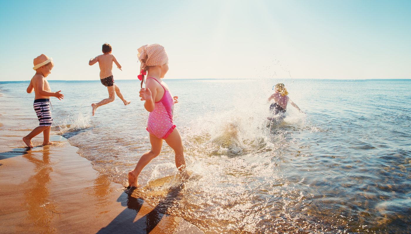 Allara, Eglinton four children running into the waves at local beach.