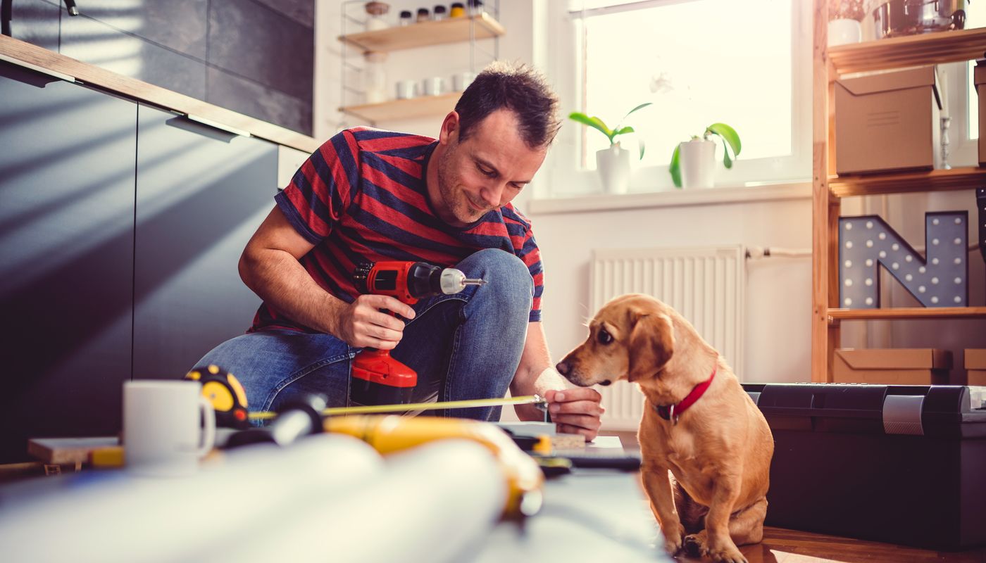 Cassia, Kwinana male measuring up and putting furniture together with a small dog by his side