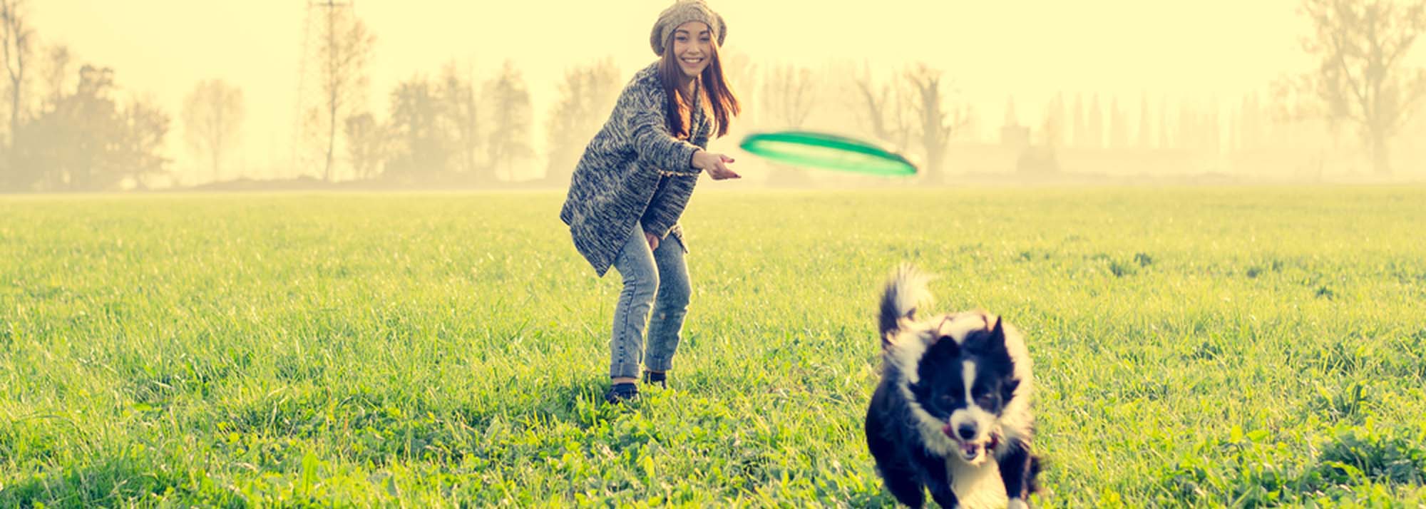 Lady playing fetch with her dog