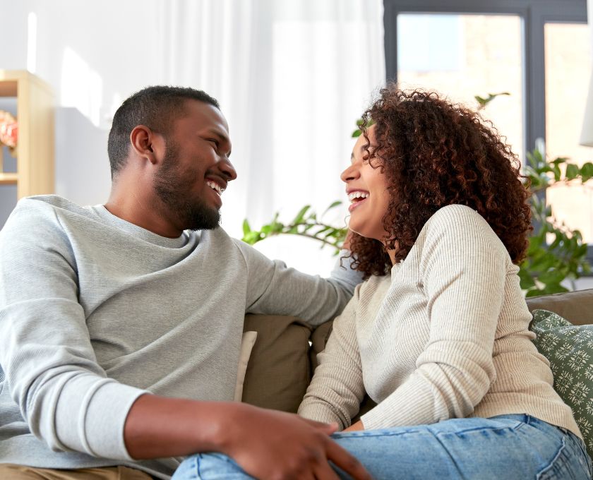 Cassia, Kwinana young couple sitting on the couch laughing