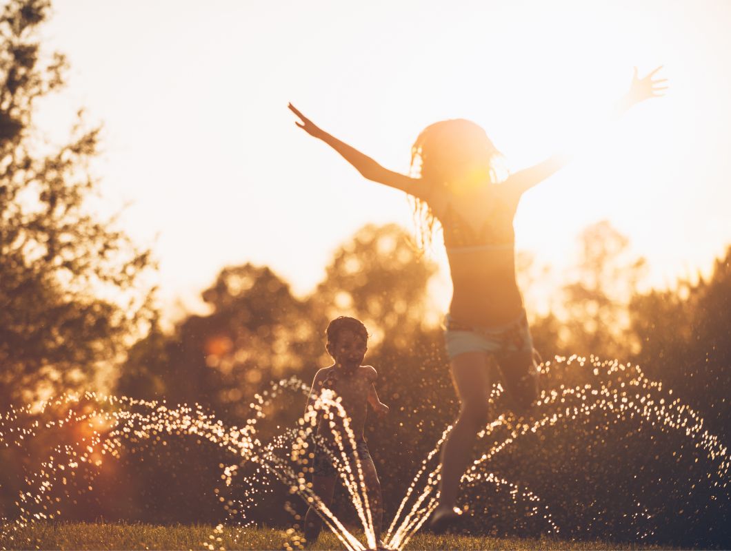 Children running through sprinklers, the history of Allara, Eglinton.