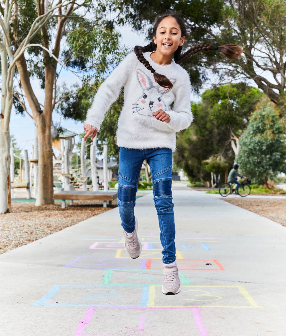 Maple Grove, Pakenham young girl playing hop scotch on park footpath.