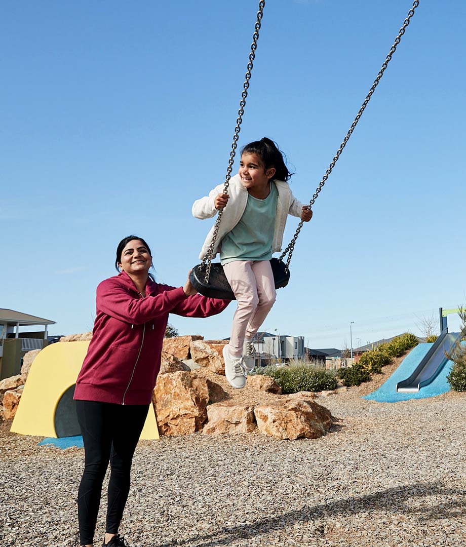 Botanical, Mickleham mother pushing young daughter on swing set v2.