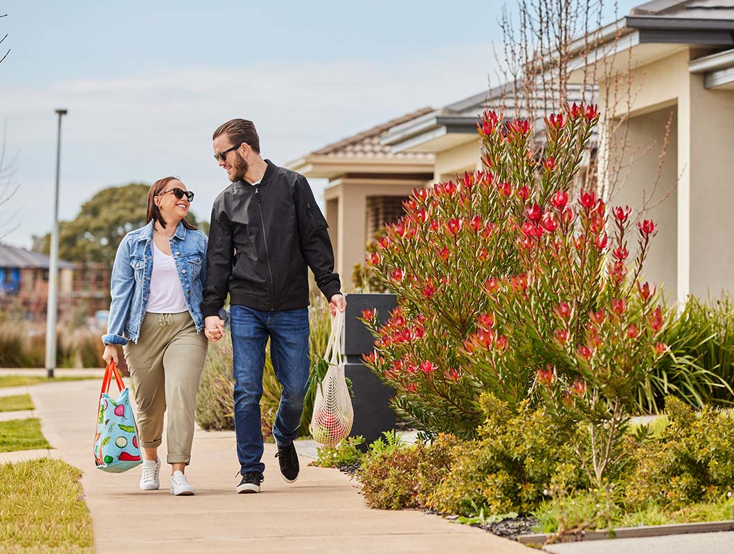 Young couple walking along foot path.