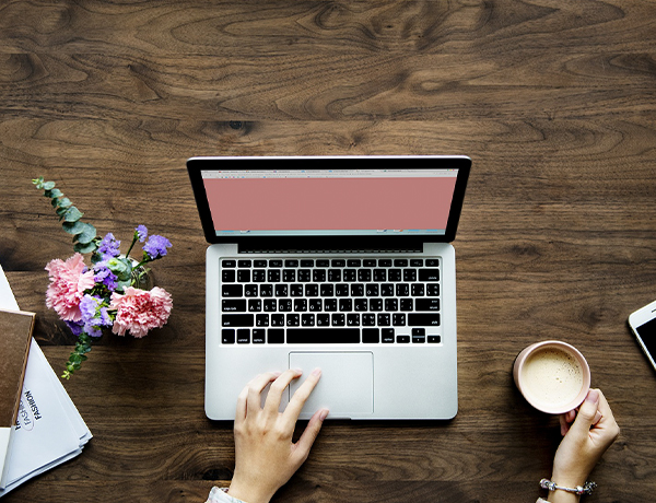 Lady with a cup of coffee and laptop