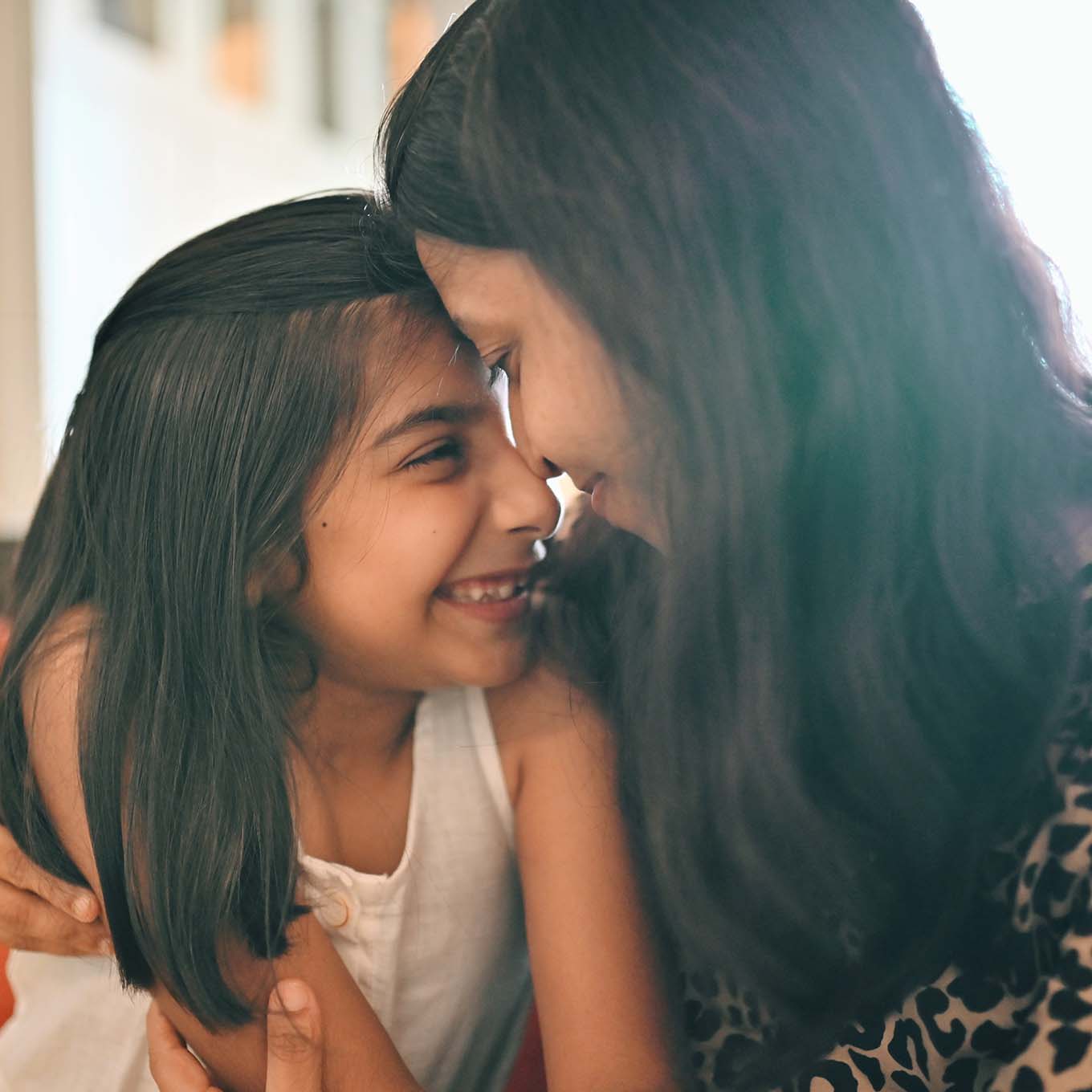 Mother and daughter hugging each other