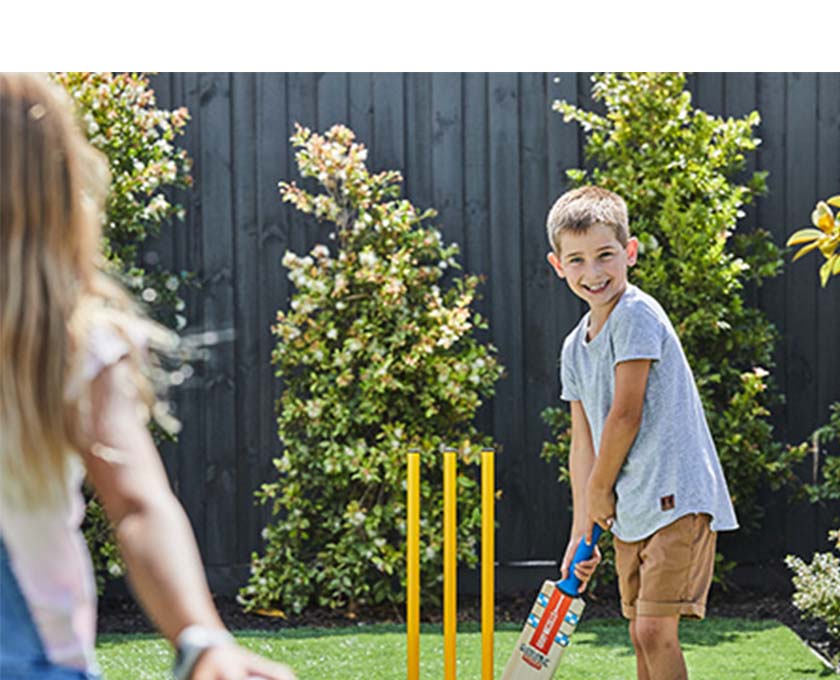 Maple Grove, Pakenham young children playing backyard cricket.