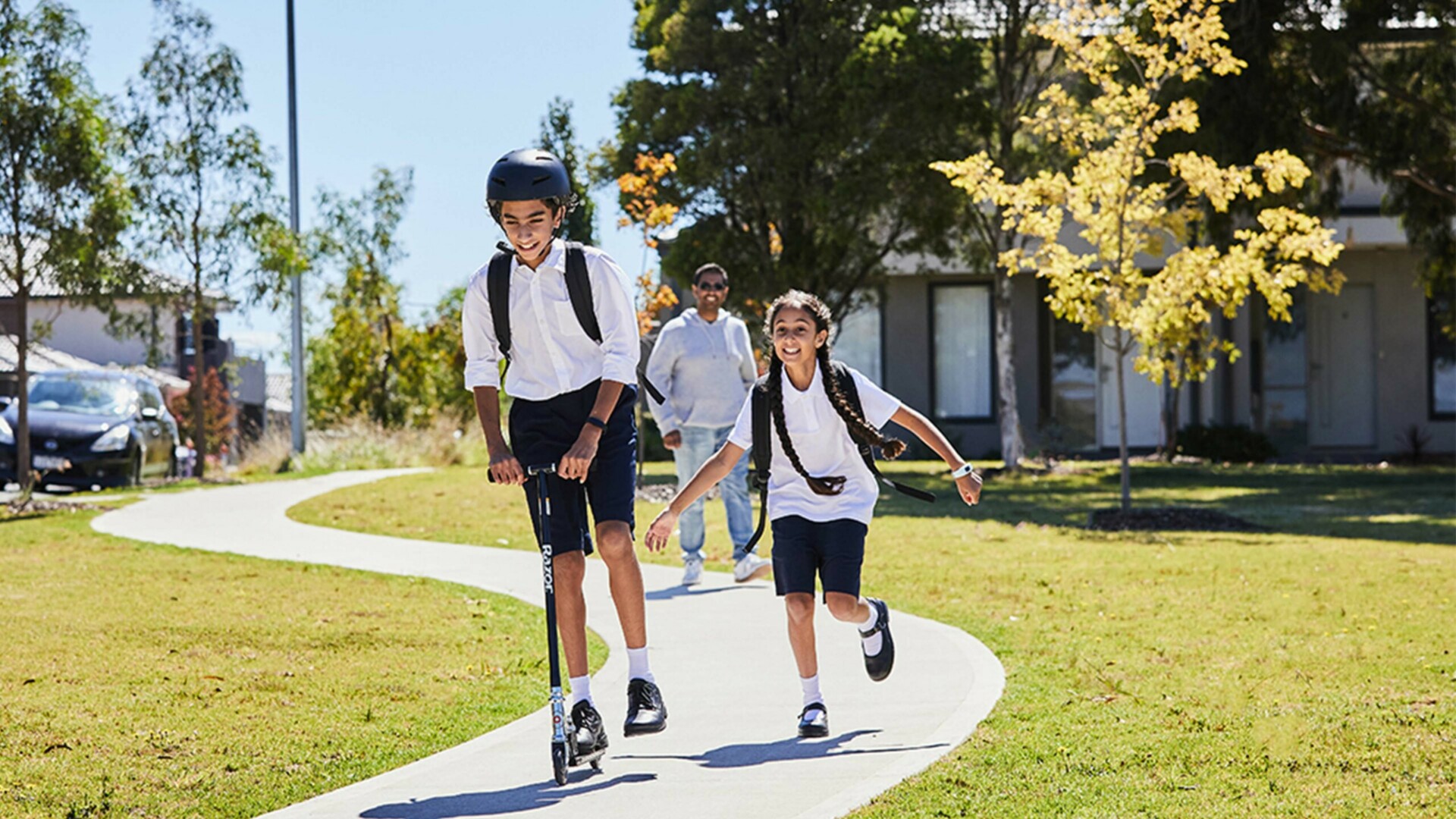 Maple Grove, Pakeham school kids riding scooter and running with father walking not too far behind v2.