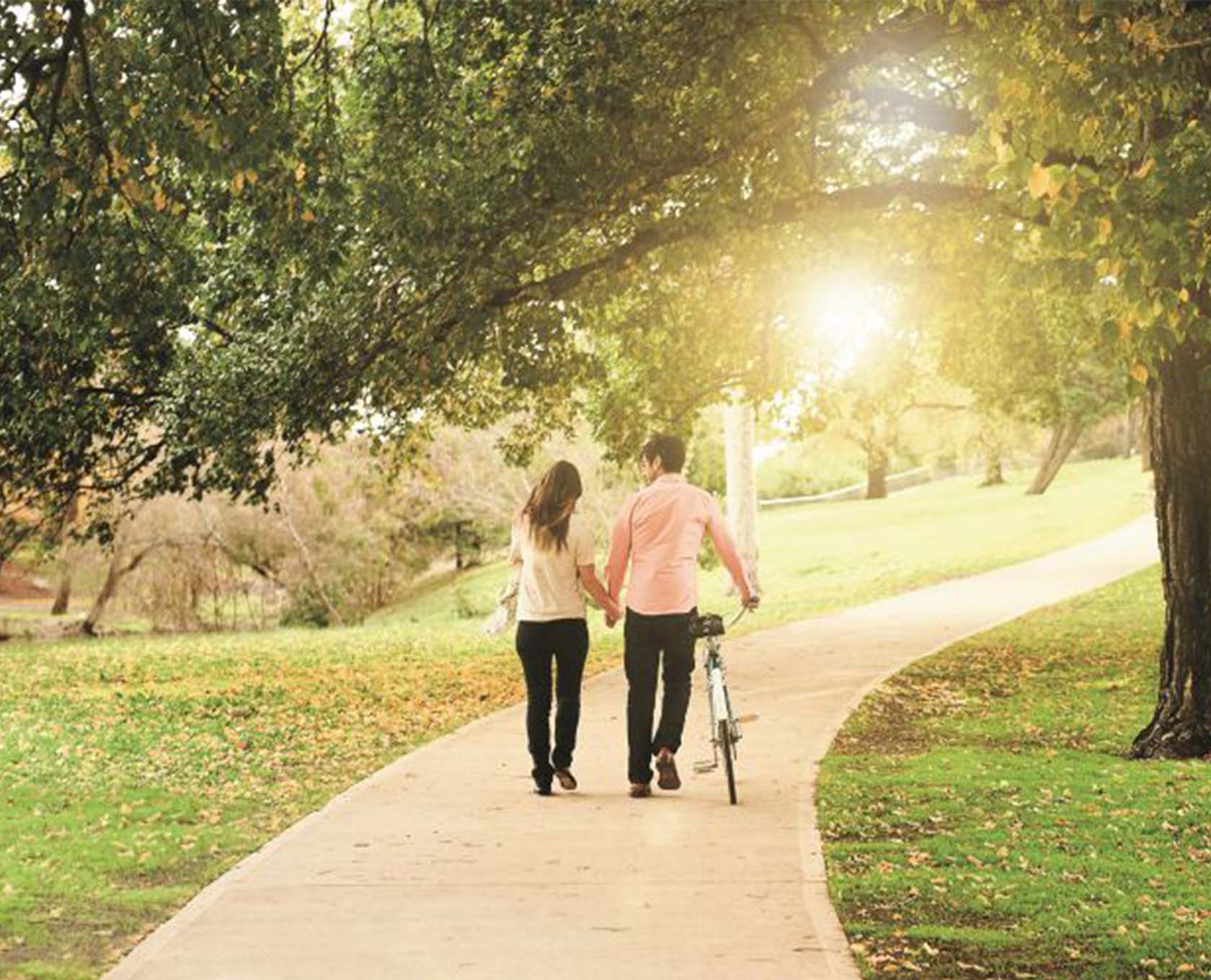 Young couple walking through the park