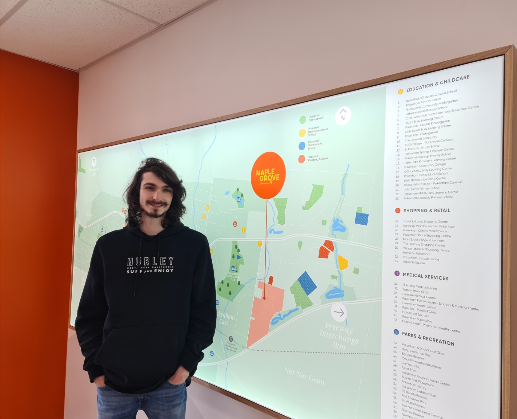 Maple Grove, Pakenham - Customer Testimonial, Jesse standing in front of masterplan at sales office.