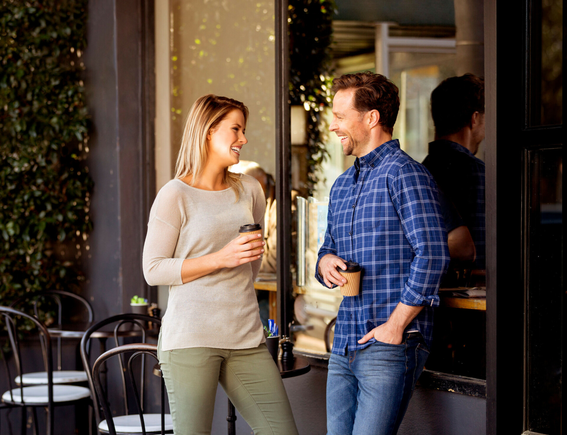 Arcadia, Officer man and woman standing outside a shop drinking takeaway coffee
