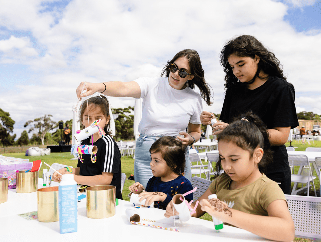 True North, Greenvale community event, craft station with a mother and her children.