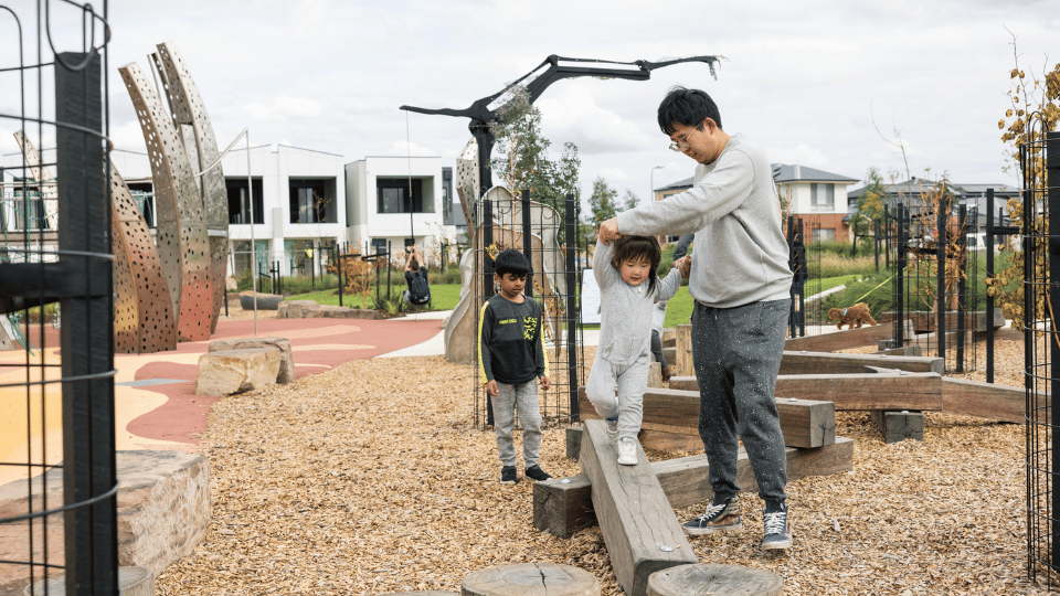 Family playing in playground at Botanical