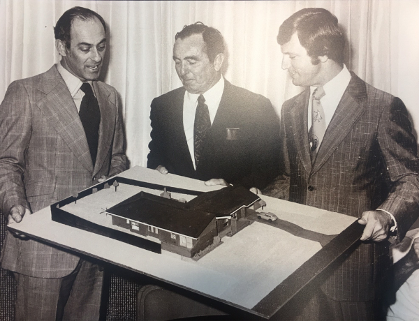 Nigel Satterley AM looking at a house model
