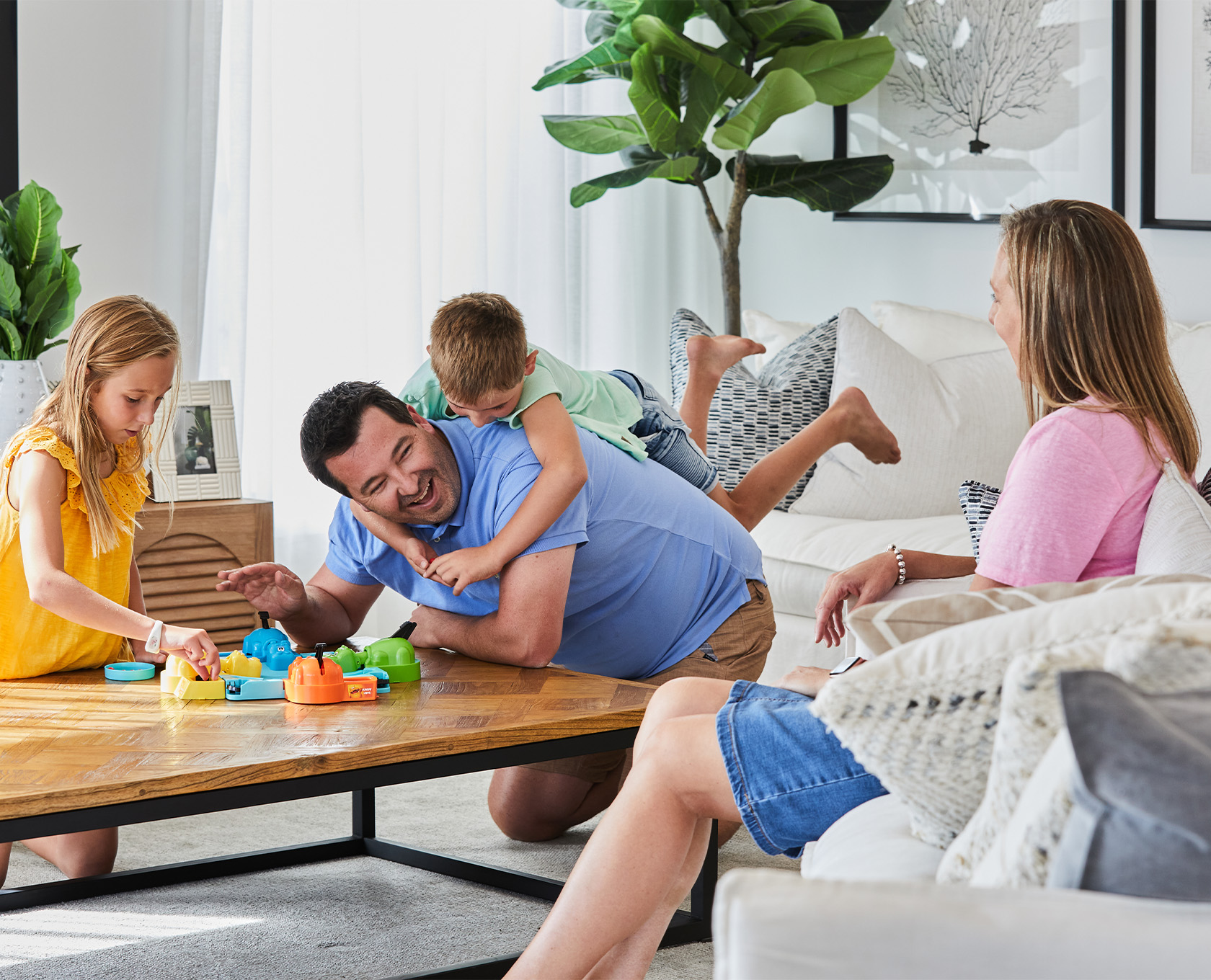 Bluestone, Tarneit young family playing around the lounge room coffee table.