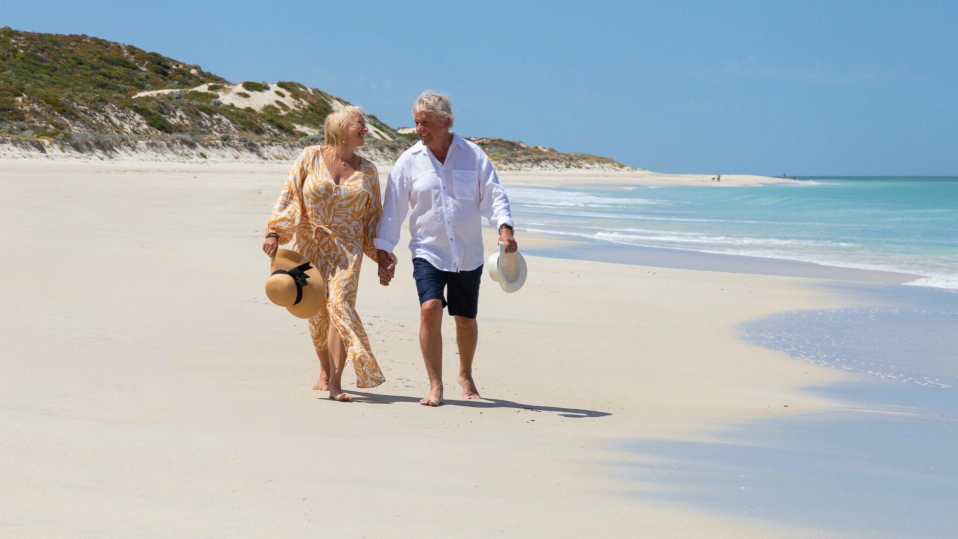 Older couple walking along the beach