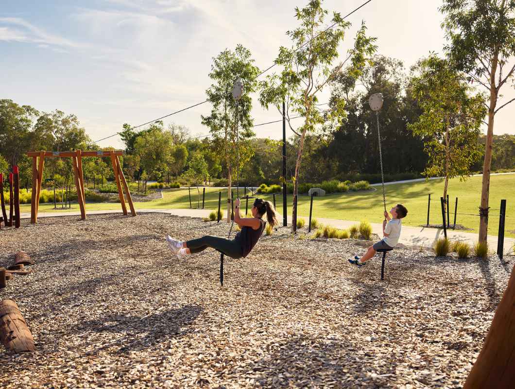 Mother and son playing on the swing set at Clementine