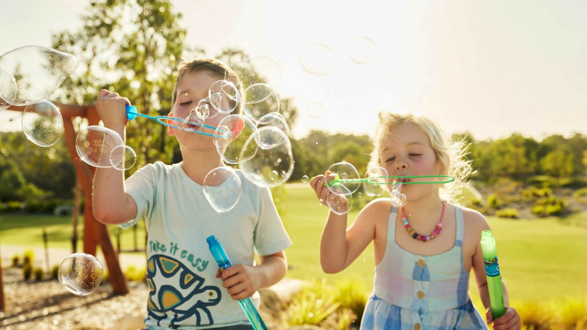 Young children blowing bubbles in Clementine in Upper Swan