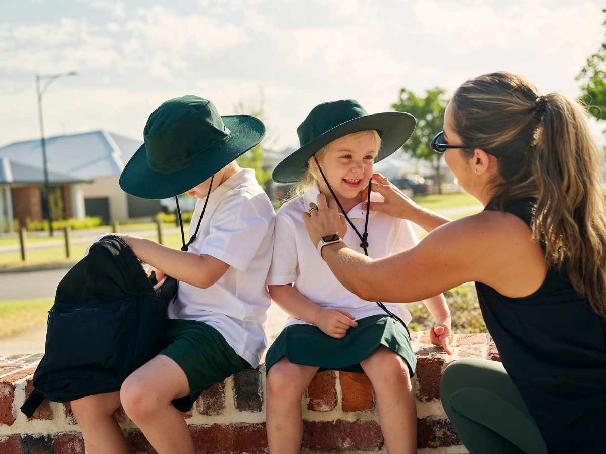 Young mother getting children ready for school