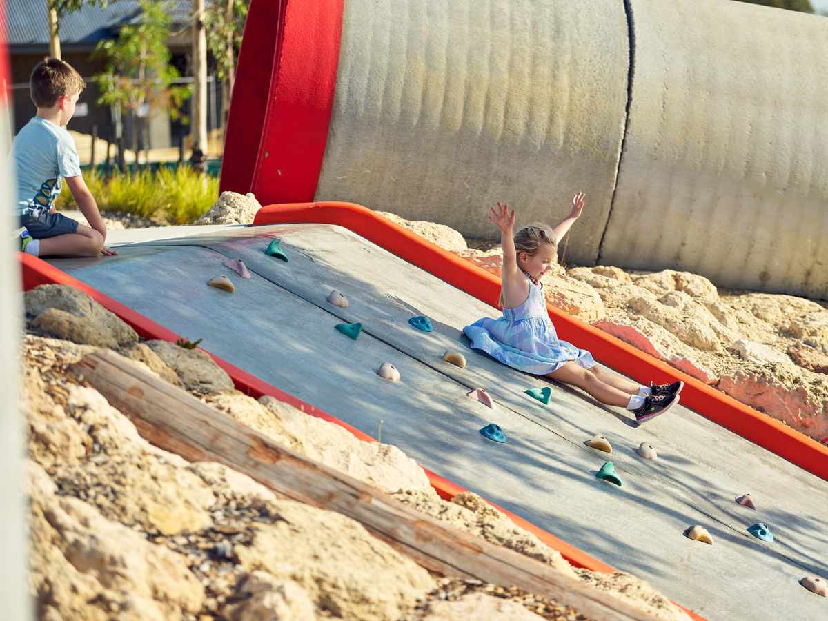 Young children sliding down the slide at Clementine in Upper Swan