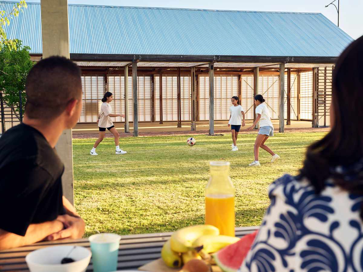 Family kicking the soccer ball in Clementine in Upper Swan
