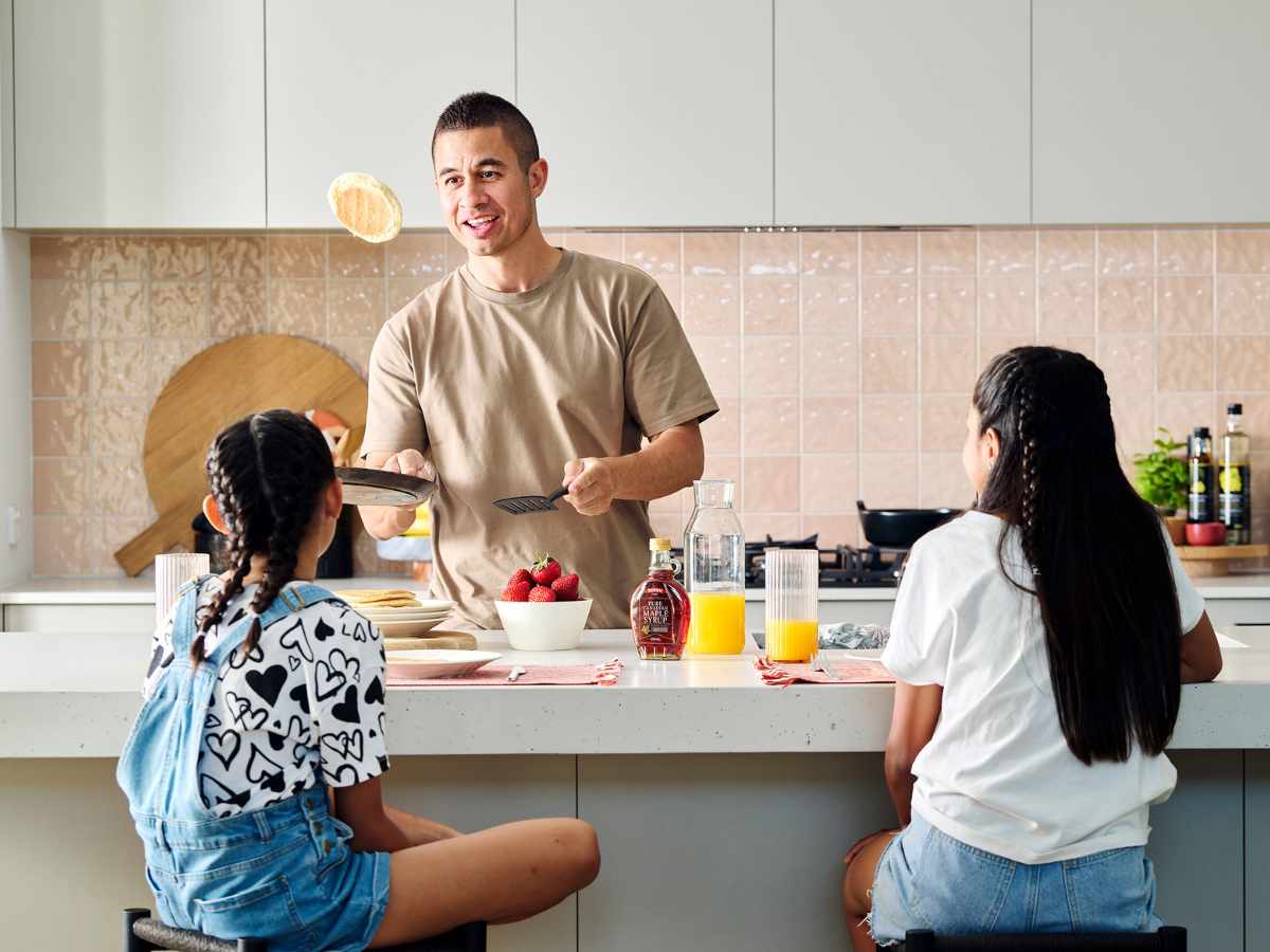 Young father making pancakes for this daughters in Clementine, Upper Swan