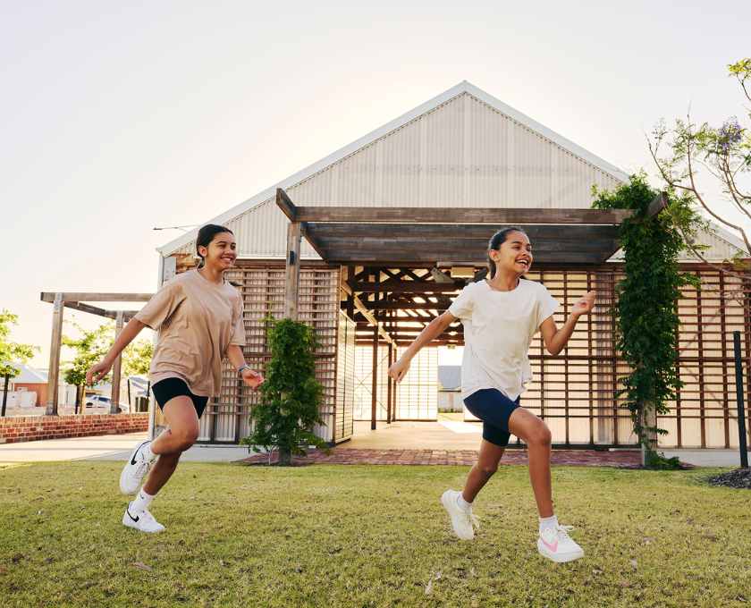 Young children running through the community space at Clementine, Upper Swan