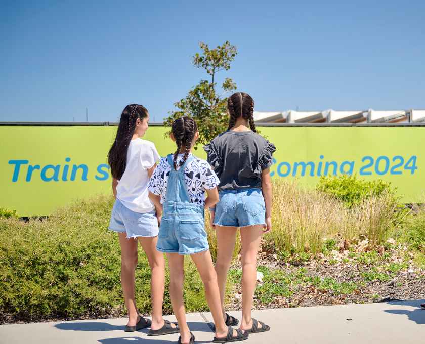 Young children looking at new signage for transport coming to Clementine in Upper Swan