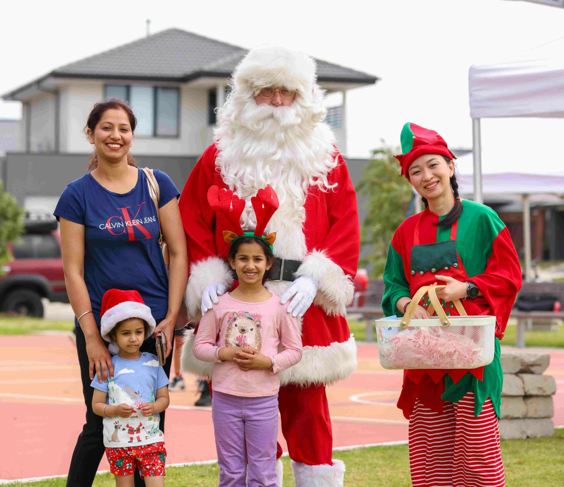 Arcadia Christmas movie night Santa Clause with his elf handing out candy canes