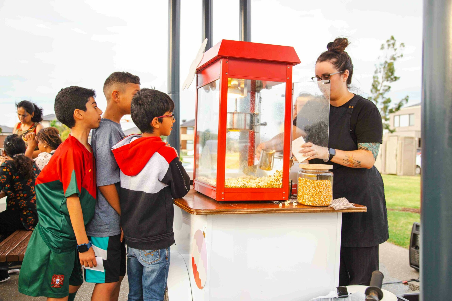 Arcadia Christmas movie night lady serving pop corn