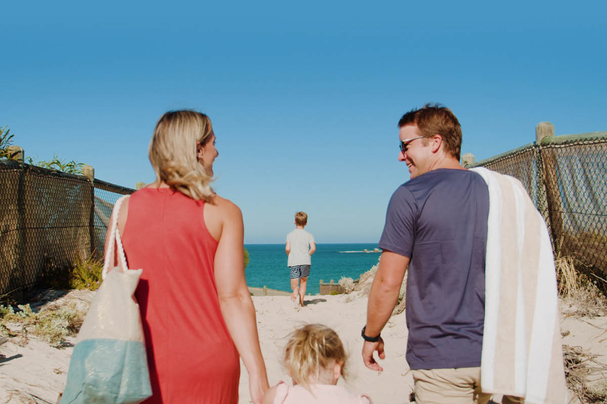 Young family walking towards the beach