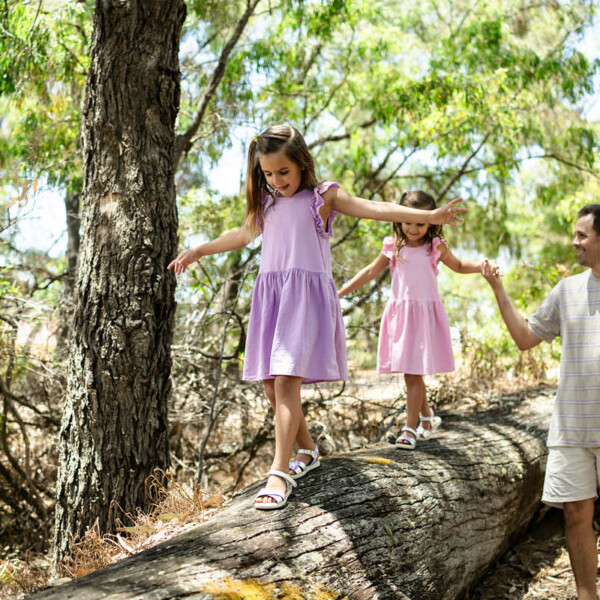 Dalyellup Beach Wildwood, girls walking along log with father