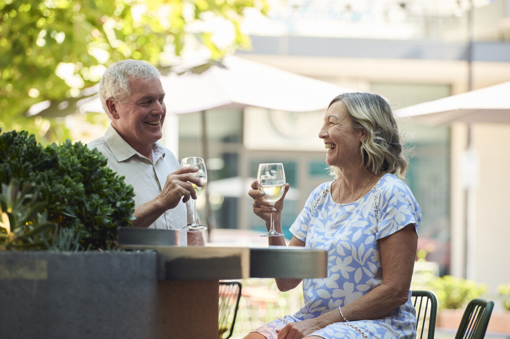 Couple sitting outdoors at Seaside Estate in Madora Bay